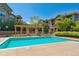 Outdoor pool with pergola, landscaping, and multi-story homes in the background at 18669 Stroh Rd # 10208, Parker, CO 80134