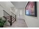 Bright entryway with wood-look floors, modern staircase, and large artwork at 1161 E Witherspoon Dr, Elizabeth, CO 80107