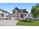 Two-story craftsman style home with gray and white siding, and a three-car garage at 1161 E Witherspoon Dr, Elizabeth, CO 80107