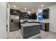 Modern kitchen with dark cabinetry, granite countertops, and stainless steel appliances at 1161 E Witherspoon Dr, Elizabeth, CO 80107