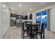 Modern kitchen with dark cabinetry, granite island, and stainless steel appliances at 1161 E Witherspoon Dr, Elizabeth, CO 80107