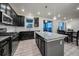 Modern kitchen with dark cabinetry, granite island, and stainless steel appliances at 1161 E Witherspoon Dr, Elizabeth, CO 80107