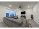 Spacious living room with sectional sofa, large windows, and ceiling fan at 1161 E Witherspoon Dr, Elizabeth, CO 80107