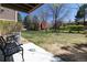 A bench seat and concrete patio with a grassy area with benches, tables, and trees at 2716 E Otero Pl # 6, Centennial, CO 80122