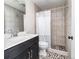 Bathroom with tiled shower, pebble floor and dark vanity cabinet at 2716 E Otero Pl # 6, Centennial, CO 80122