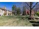 View of the community's expansive lawn area, perfect for recreation, with a picnic table and mature trees at 2716 E Otero Pl # 6, Centennial, CO 80122