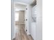 Hallway with wood-look floors leads to in-unit stacked washer and dryer at 2716 E Otero Pl # 6, Centennial, CO 80122