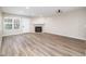 Living room with wood-look floors, fireplace, and large window with bright natural light at 2716 E Otero Pl # 6, Centennial, CO 80122