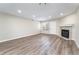 Living room featuring a modern fireplace, wood-look floors, and bright natural light from window at 2716 E Otero Pl # 6, Centennial, CO 80122