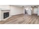 Open living room with a fireplace, wood-look flooring, and access to the kitchen at 2716 E Otero Pl # 6, Centennial, CO 80122