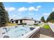 A backyard featuring a pool, hot tub, and meticulously designed patio with ample greenery at 49 Charlou Cir, Cherry Hills Village, CO 80111