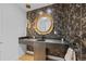 Elegant powder room features unique wallpaper, a gold-framed mirror, and a stylish sink at 49 Charlou Cir, Cherry Hills Village, CO 80111