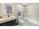 Modern bathroom with a sleek vanity, a shower-tub combo and modern fixtures at 49 Charlou Cir, Cherry Hills Village, CO 80111