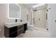 Modern bathroom with a sleek vanity, glass-enclosed shower, and stylish fixtures at 49 Charlou Cir, Cherry Hills Village, CO 80111
