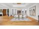 Dining room with modern chandelier, glass table, and neutral decor, complemented by natural light at 49 Charlou Cir, Cherry Hills Village, CO 80111