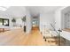 Hallway featuring a glass railing and hardwood floors, connecting multiple rooms with natural light at 49 Charlou Cir, Cherry Hills Village, CO 80111