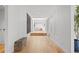 Bright hallway with hardwood floors leads to a living space with large windows and a skylight at 49 Charlou Cir, Cherry Hills Village, CO 80111