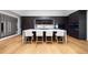 The kitchen has hardwood floors, dark wood cabinets, stainless steel appliances, and a marble breakfast bar at 49 Charlou Cir, Cherry Hills Village, CO 80111