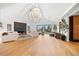 Bright living room with a vaulted ceiling, modern fireplace, and a large spherical chandelier at 49 Charlou Cir, Cherry Hills Village, CO 80111
