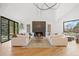 Open living room featuring a modern fireplace, vaulted ceiling, and a view to the outside at 49 Charlou Cir, Cherry Hills Village, CO 80111