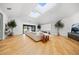 Bright living room with skylights, modern fireplace, and expansive windows for natural light at 49 Charlou Cir, Cherry Hills Village, CO 80111