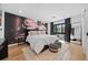 Modern bedroom features a flower mural, plush bedding, and a large window with natural light at 49 Charlou Cir, Cherry Hills Village, CO 80111