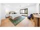 Bright bedroom with wood floors, neutral decor, and a large window view at 49 Charlou Cir, Cherry Hills Village, CO 80111