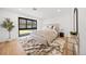 Cozy main bedroom with wood floors, stylish rug, and neutral tones at 49 Charlou Cir, Cherry Hills Village, CO 80111