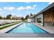 The backyard pool area features lounge chairs and seating, with beautiful blue skies overhead at 49 Charlou Cir, Cherry Hills Village, CO 80111