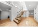 Modern staircase with glass railings and floating wooden steps leads to a bright, open space at 49 Charlou Cir, Cherry Hills Village, CO 80111