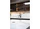 The stylish wet bar area features modern cabinets, marble countertops and designer fixtures at 49 Charlou Cir, Cherry Hills Village, CO 80111