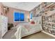 Bright bedroom featuring trendy wallpaper, pink accents, and a large window allowing plenty of natural light at 5478 Water Oak Cir, Castle Rock, CO 80108