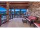 Inviting covered patio with stone pillars and comfortable seating, ideal for outdoor relaxation at 5478 Water Oak Cir, Castle Rock, CO 80108
