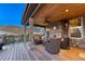 Inviting covered patio with stone pillars, ceiling fan, and beautiful view at 5478 Water Oak Cir, Castle Rock, CO 80108