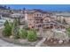 Large home with solar panels, a spacious deck, and beautiful landscaping including a waterfall at 5478 Water Oak Cir, Castle Rock, CO 80108