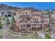 Large home with solar panels, deck, stone accents, and landscaped backyard with waterfall feature at 5478 Water Oak Cir, Castle Rock, CO 80108