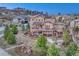 Backyard view of home with solar panels, deck, landscaped yard with stone pathway and firepit at 5478 Water Oak Cir, Castle Rock, CO 80108