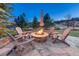 Inviting stone fire pit area with Adirondack chairs perfect for outdoor relaxation and entertaining at 5478 Water Oak Cir, Castle Rock, CO 80108