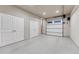 Clean, empty garage with epoxy flooring and ample storage space with cabinets at 5478 Water Oak Cir, Castle Rock, CO 80108