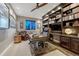 Elegant home office with custom built-in bookshelves, dark wood accents, and a leather chair at 5478 Water Oak Cir, Castle Rock, CO 80108