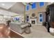 Open-concept living room with a fireplace, high ceilings, and many windows at 5478 Water Oak Cir, Castle Rock, CO 80108