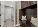 Mud room with storage bench, dark wood accents, and access to laundry at 5478 Water Oak Cir, Castle Rock, CO 80108