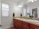 Double vanity bathroom with mosaic tile accents at 9217 E 4Th Pl, Denver, CO 80230