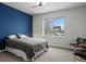 Bedroom with blue accent wall and a large window at 9217 E 4Th Pl, Denver, CO 80230