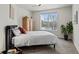 Bedroom with wood armoire and window views at 9217 E 4Th Pl, Denver, CO 80230