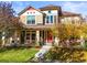 Beautiful two-story home with autumn landscaping and red front door at 9217 E 4Th Pl, Denver, CO 80230