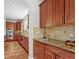 Spacious kitchen boasts granite countertops and ample cabinetry at 9217 E 4Th Pl, Denver, CO 80230