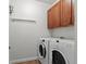 Bright laundry room with washer, dryer, and ample cabinetry at 9217 E 4Th Pl, Denver, CO 80230