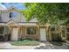 Charming townhouse exterior with stone facade, well-manicured landscaping, and a welcoming entrance at 2141 Coronado N Pkwy # C, Denver, CO 80229
