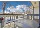 Cozy balcony featuring wooden railing and table overlooking a quiet neighborhood at 1868 S Ammons St # D, Lakewood, CO 80232